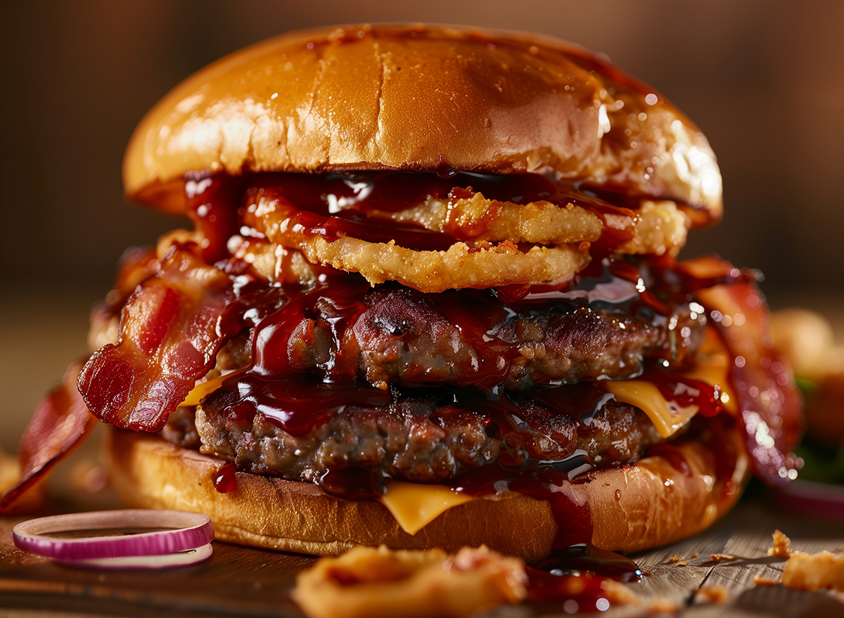 Beef burger with BBQ sauce, bacon, cheddar, and onion rings