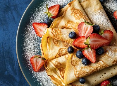 fresh homemade crepes artfully arranged on a plate