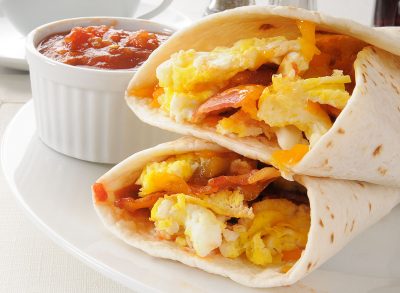 A plate of breakfast burritos with salsa