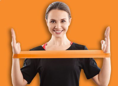 Smile woman exercising with latex resistance band in living room. Workout at home with fitnessband