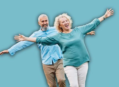 Happy active mid aged adult couple having fun walking and balancing and bonding in park or nature outdoors, healhty active mature people exercise concept