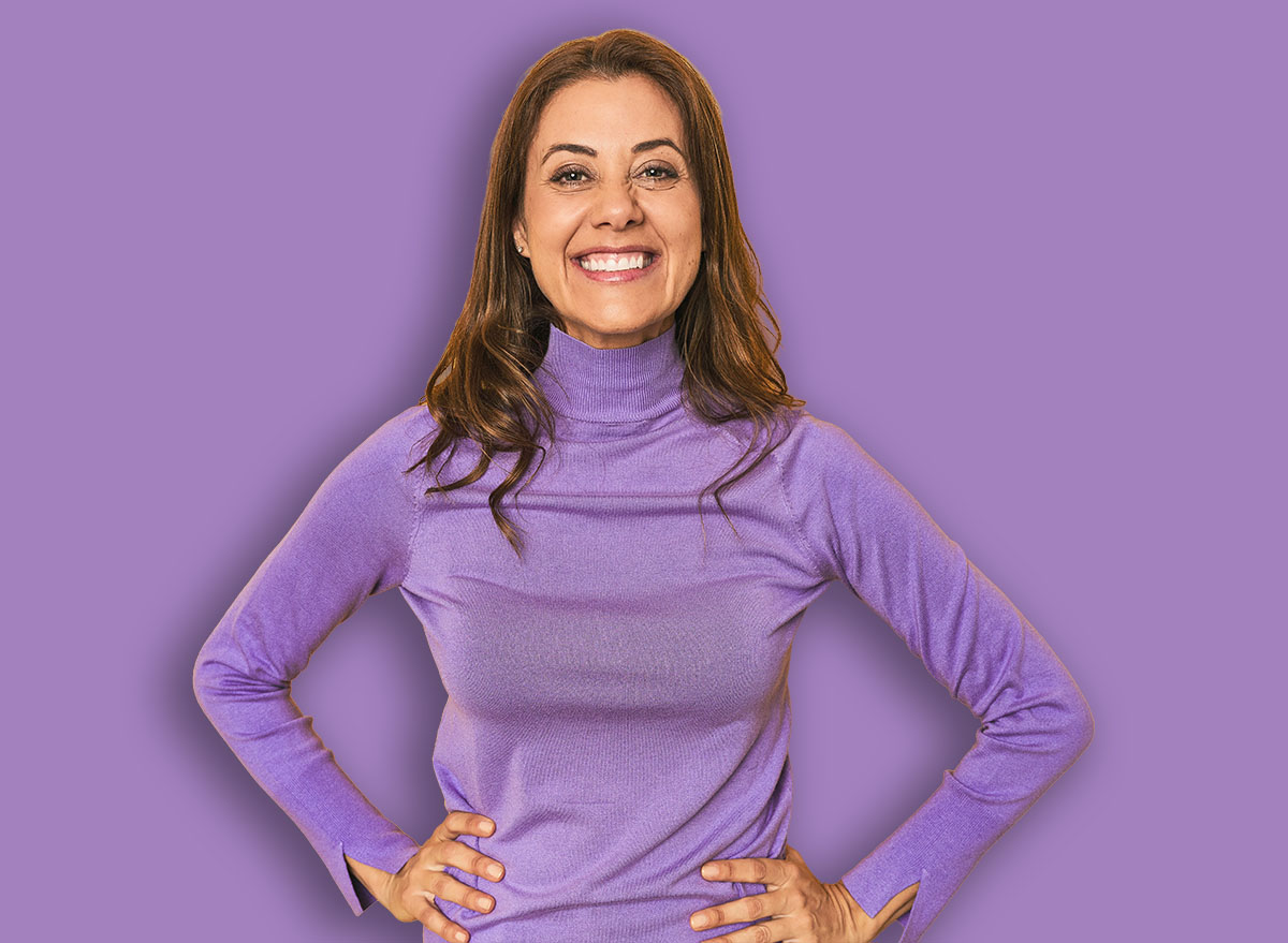 Middle-aged caucasian woman on yellow confident keeping hands on hips.