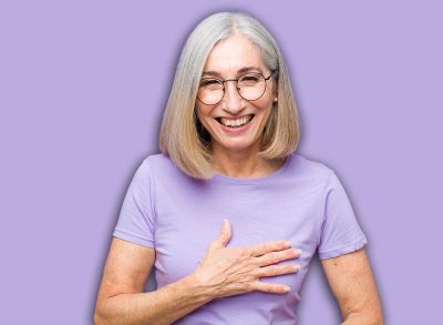 senior or middle age pretty woman laughing out loud at some hilarious joke, feeling happy and cheerful, having fun