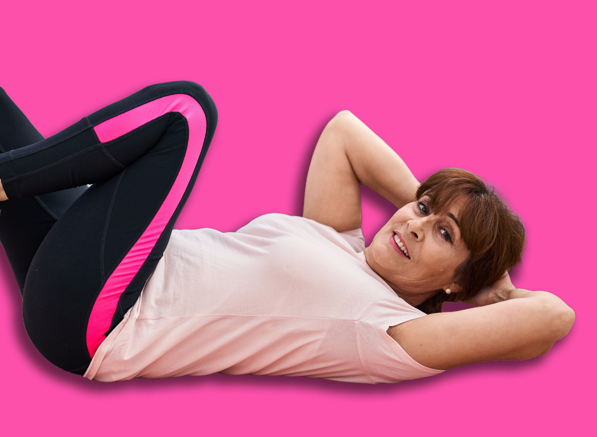 Middle age woman smiling confident training abs exercise at sport center