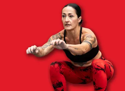 Tattooed woman exercising using box in a cross training gym