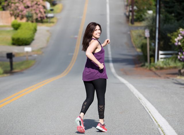 Pretty woman running down hill