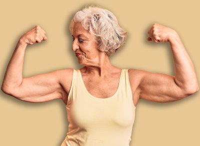 Senior grey-haired woman wearing casual clothes showing arms muscles smiling proud. fitness concept.