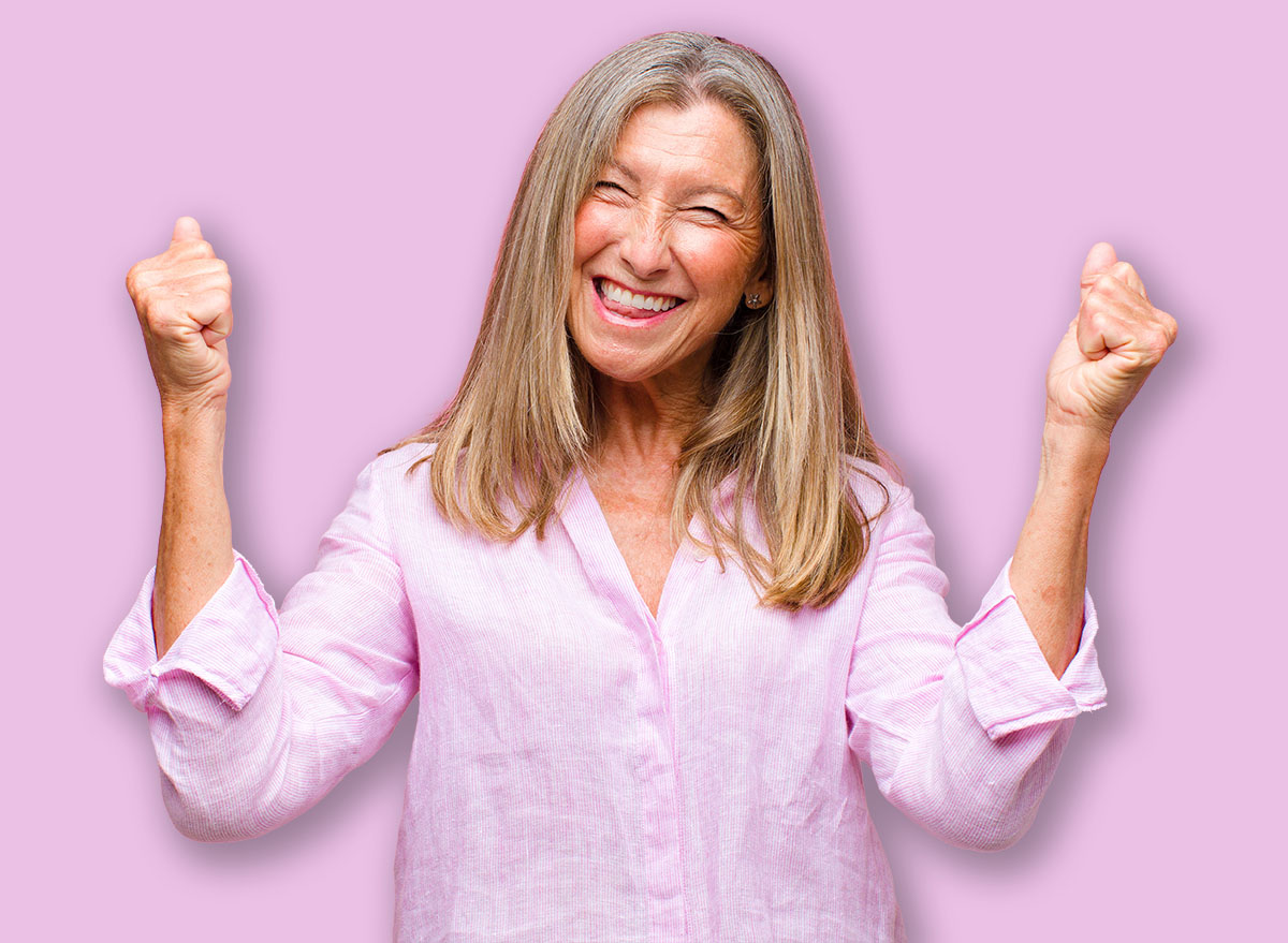 middle age pretty woman feeling shocked, excited and happy, laughing and celebrating success, saying wow!