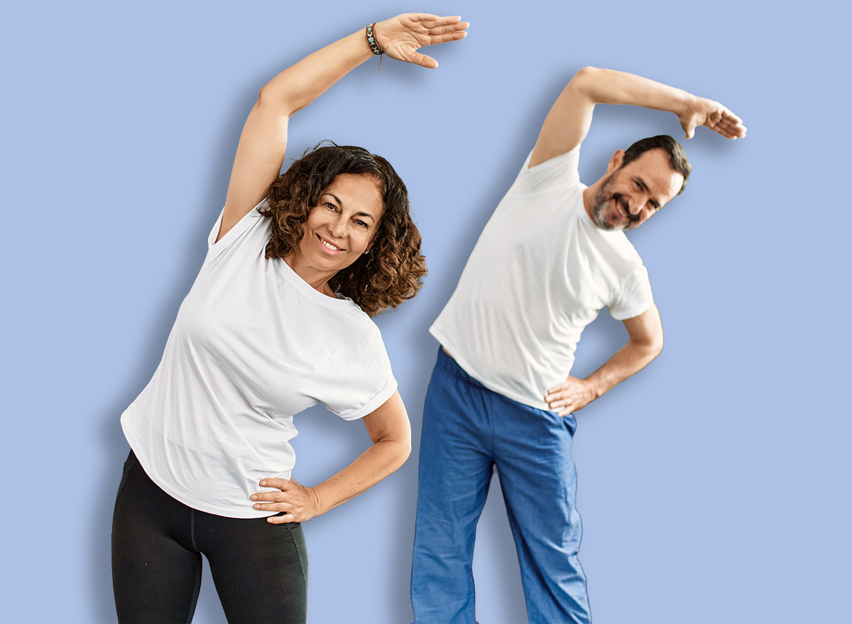 Middle age hispanic couple smiling happy training at home.