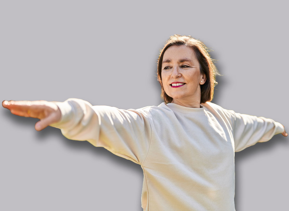 Middle age woman smiling confident training yoga at park