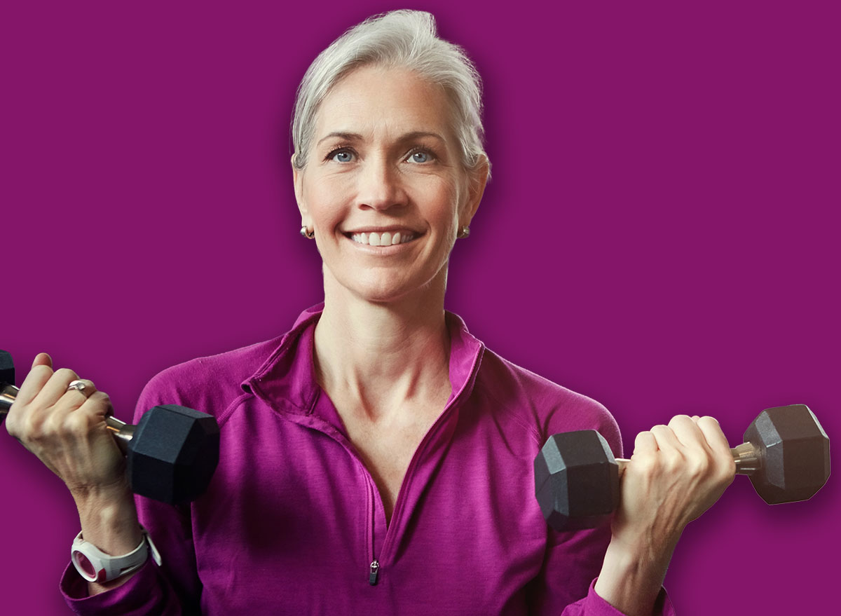 Mature people, woman and dumbbell in class for fitness, coaching and muscle development in gym. Senior group, men and exercise for arms, health and happy for weightlifting workout at wellness club