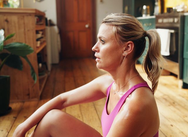 Sweaty, home fitness or woman with thinking for post workout, fatigue or morning training reflection. Tired, finish exercise session or person with health perspective, relax or contemplate body goals