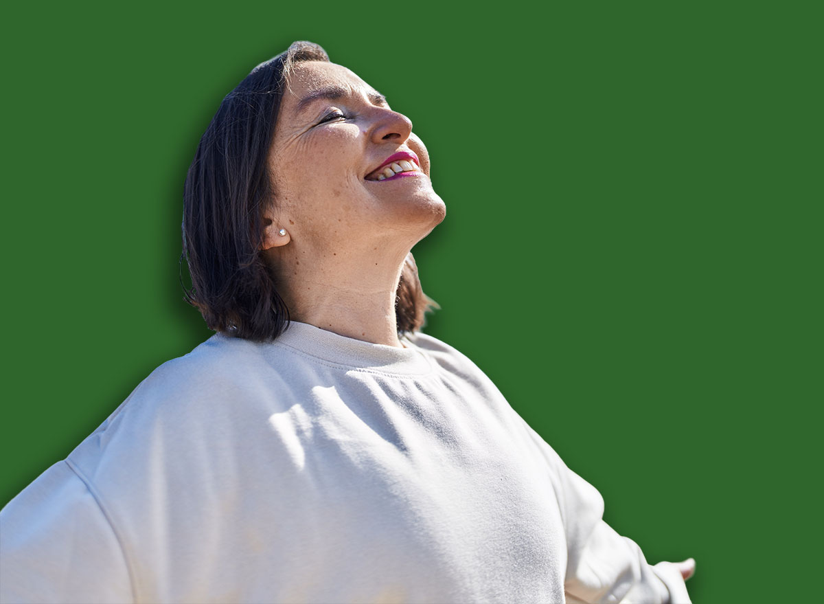 Neck Extensions. Middle age woman smiling confident breathing at seaside
