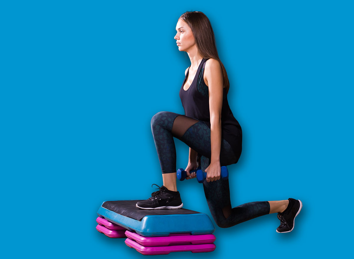 Sporty woman practice on step platform in gym