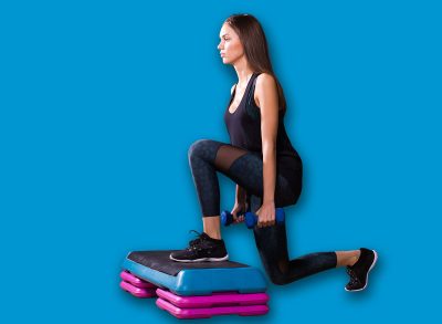 Sporty woman practice on step platform in gym