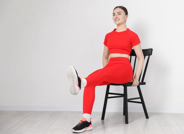 Beautiful woman stretching on chair at home, space for text