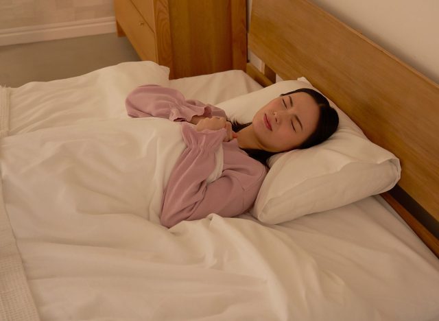 Asian woman having a nightmare while sleeping in bed at night