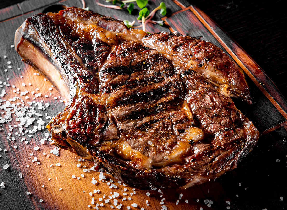 Grilled Ribeye Steak on bones on wooden board