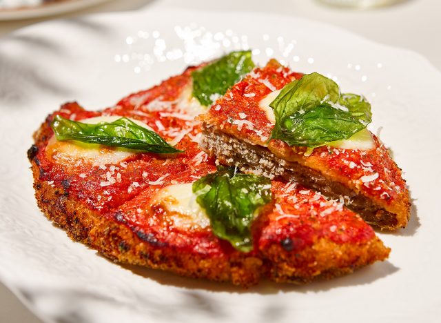breaded veal and parmesan on white ceramic plate.