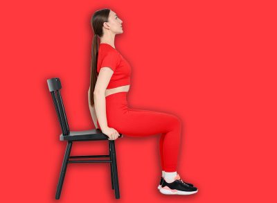 Beautiful woman exercising with chair at home