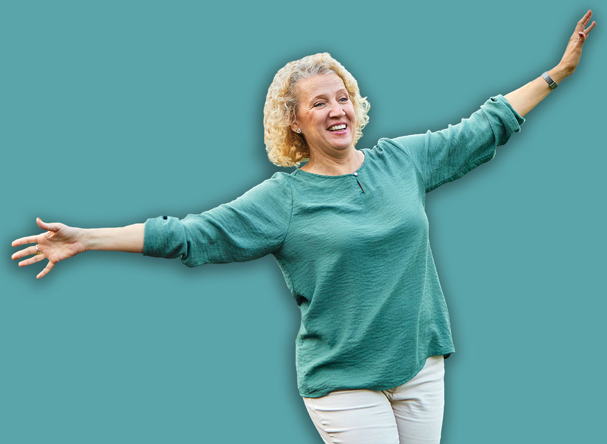 Happy active mid aged adult couple having fun walking and balancing and bonding in park or nature outdoors, healhty active mature people exercise concept