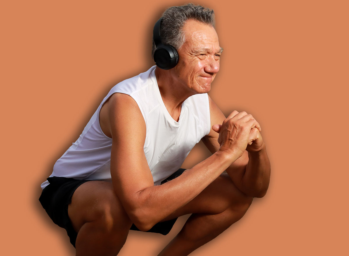 Fit Older Man at the Park exercising doing deep squats