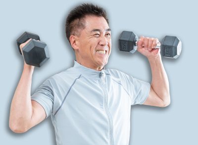 Senior Asian man doing strength training with dumbbells