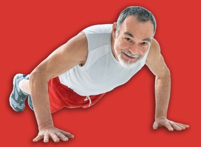 senior man doing push-ups exercise in gym.