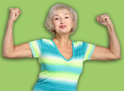 Senior woman exercising on light grey background
