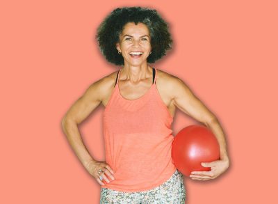 Indoor portrait of happy fit mature woman holding soft ball, active and sport lifestyle