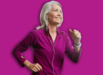 Senior woman, running on treadmill and smile for music in gym club, cardio and breathing for health in wellness. Mature, female runner and exercise with podcast, happy and workout by speed machine