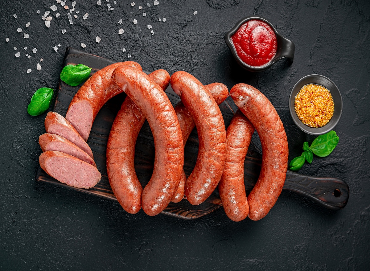 Smoked,polish,Sausages,In,Vacuum,Packaging.,Top,View.,On,A,Black
