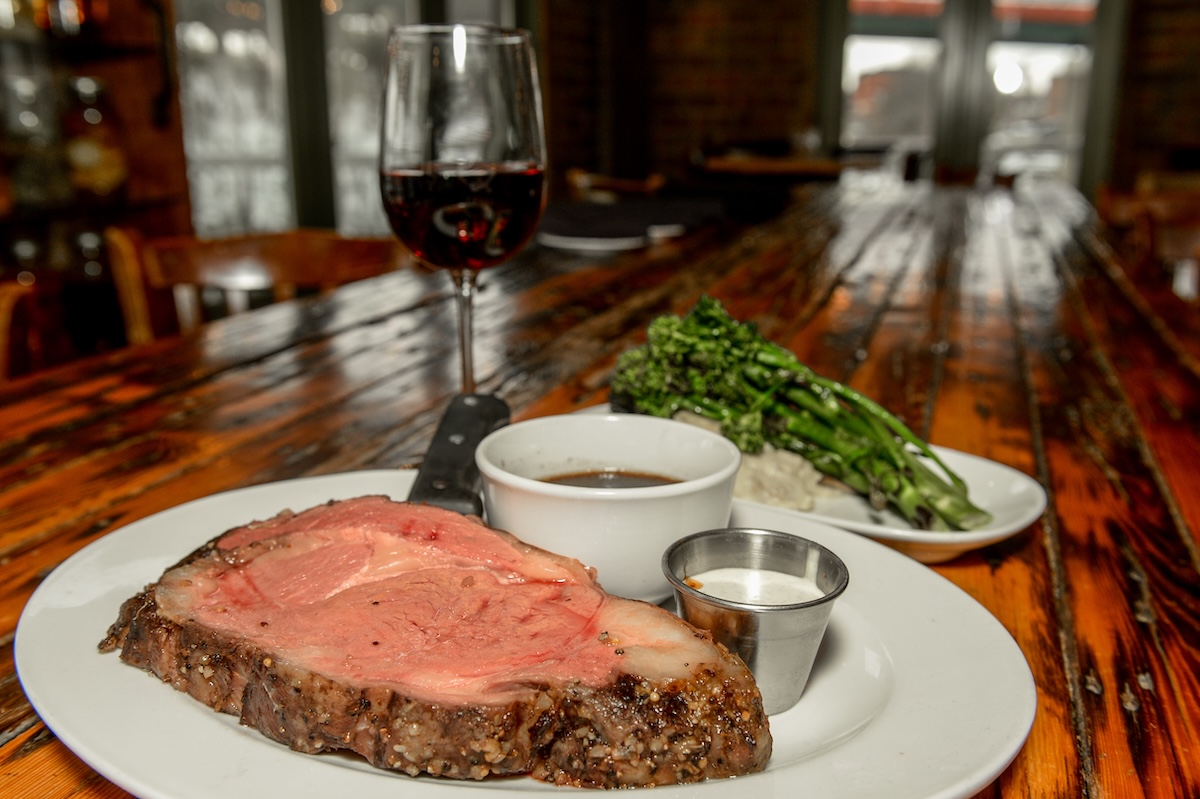 Prime,Rib,With,Broccolini,And,Wine,Sitting,On,Wood,Bar