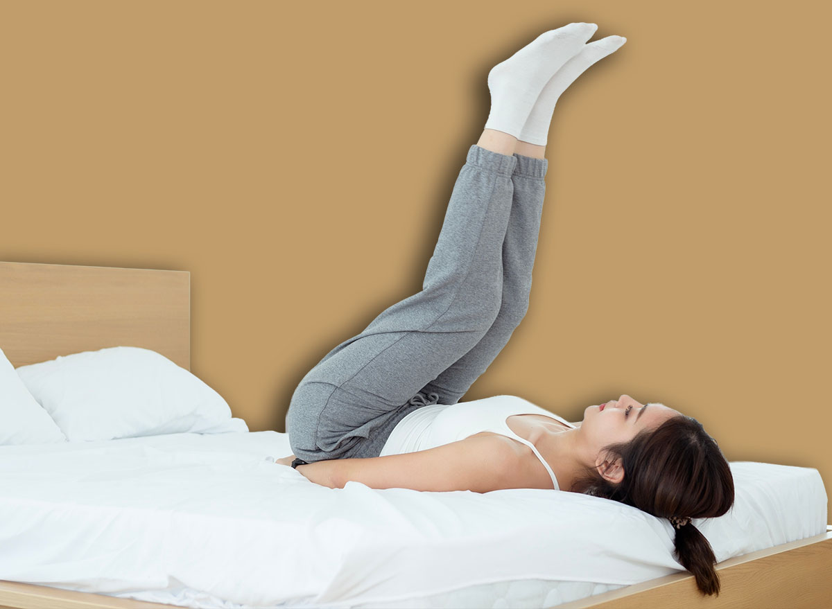 Young Asian woman doing exercise workout in bedroom at home