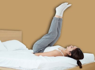 Young Asian woman doing exercise workout in bedroom at home