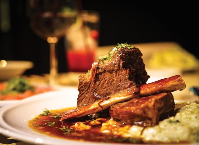 Close up of braised beef short rib on dinner table. Selective focus.