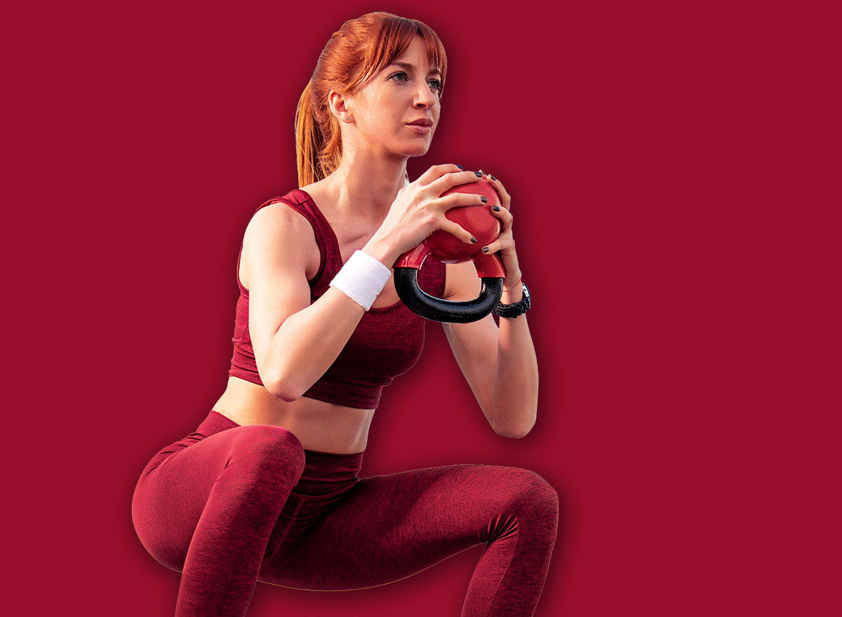 Attractive woman doing squats outdoor.