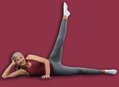 Senior woman in sportswear doing exercises on fitness mat at home