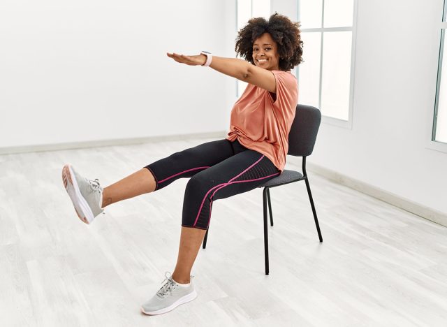 Young african american woman smiling confident stretching at sport center