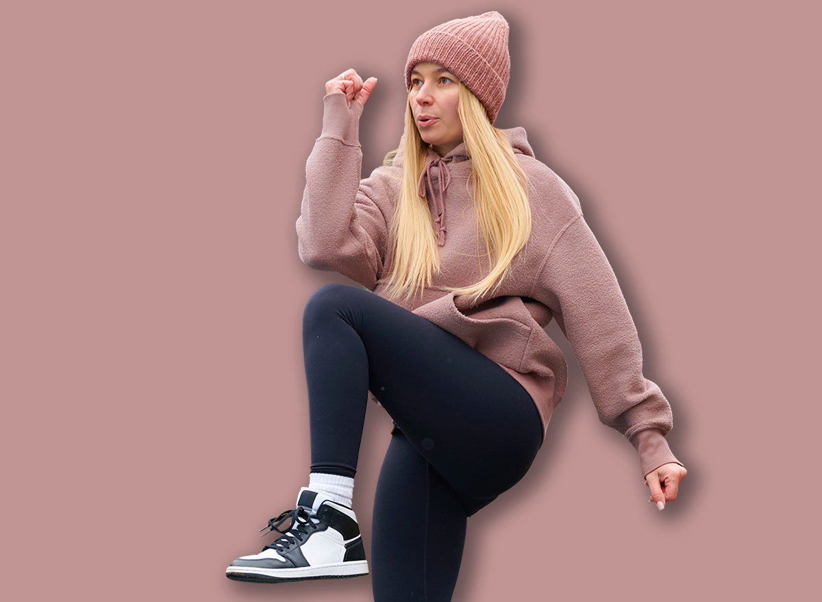 Young Woman Exercising High Knees in Outdoor Park