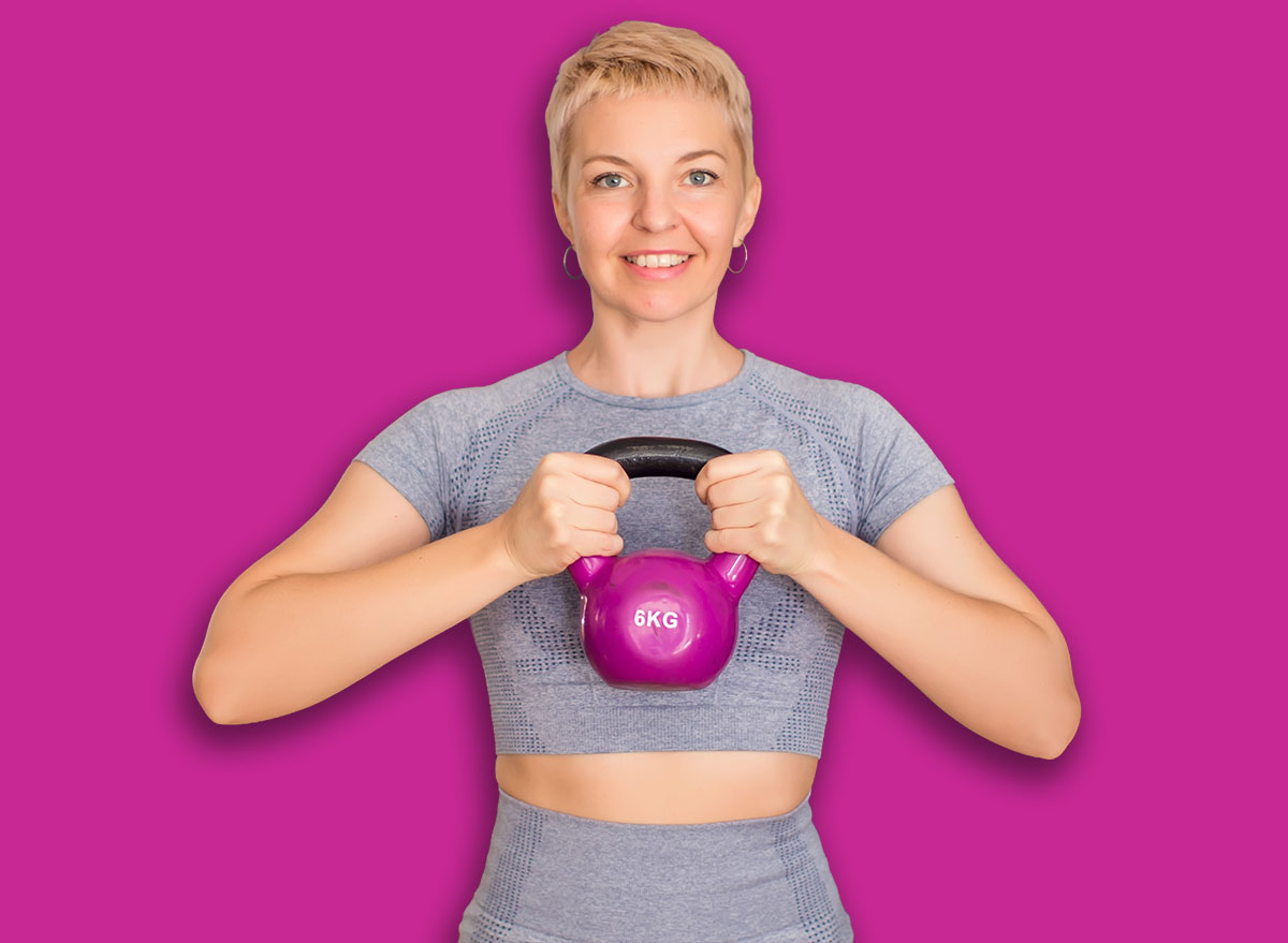 Fitness woman with kettlebell doing exercise in a gym. Health and lifestyle concept