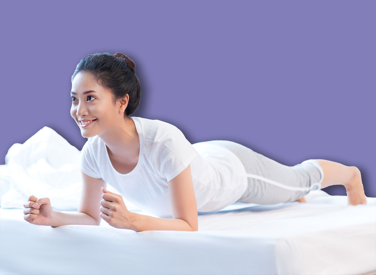 Asian women exercising in bed in the morning, she feels refreshed.She acted plank