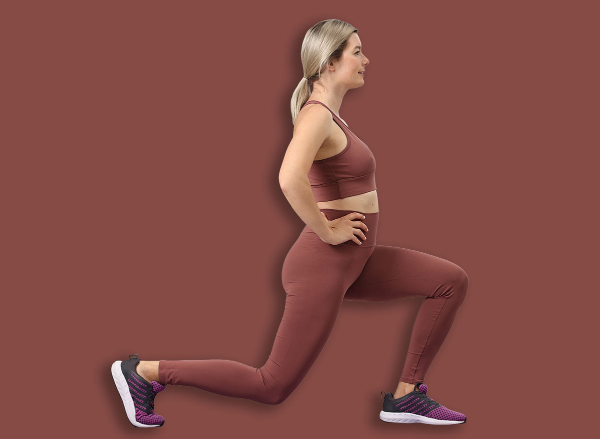 Online fitness trainer. Woman doing exercise near laptop at home