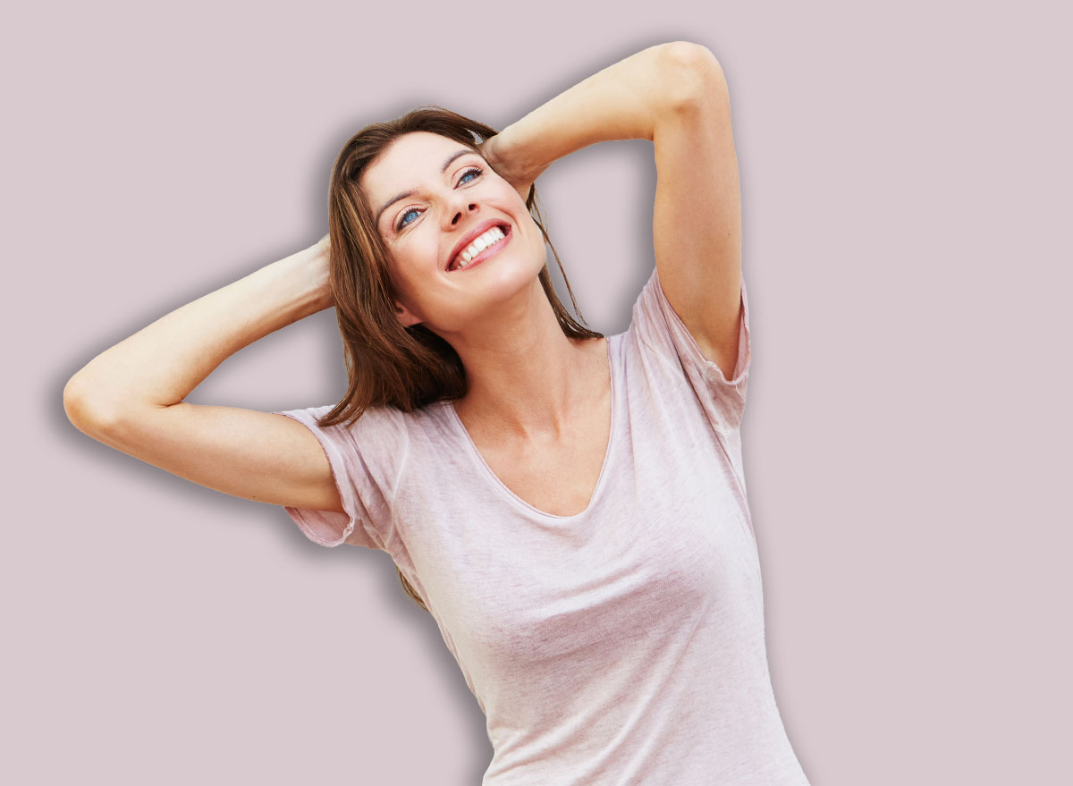 Portrait of attractive female model posing against white wall