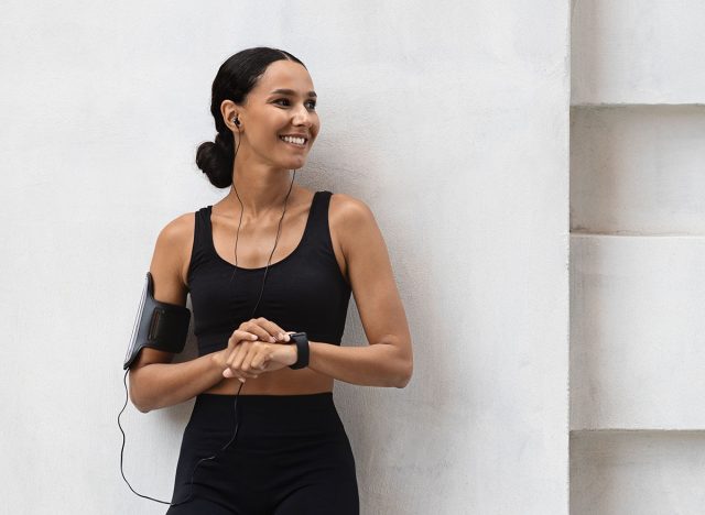 Fitness Ad. Athletic Young Lady In Stylish Sportswear Standing Outdoors Near Urban Concrete Wall, Full Length Shot Of Sporty Millennial Woman Posing Outside During Fitness Training, Copy Space