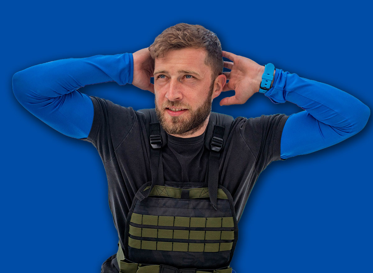 Athlete with a weight vest doing squats on the bridge