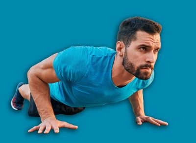 Athletic man doing pushup exercise in a city during street workout