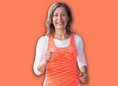 Modern mature sports woman. Cheerful lady exercising with hand weights indoors