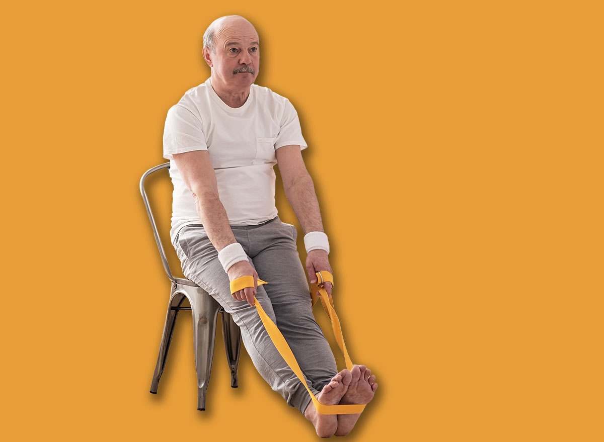 Man sitting on chair doing paschimottanasana or Intense Dorsal Stretch pose