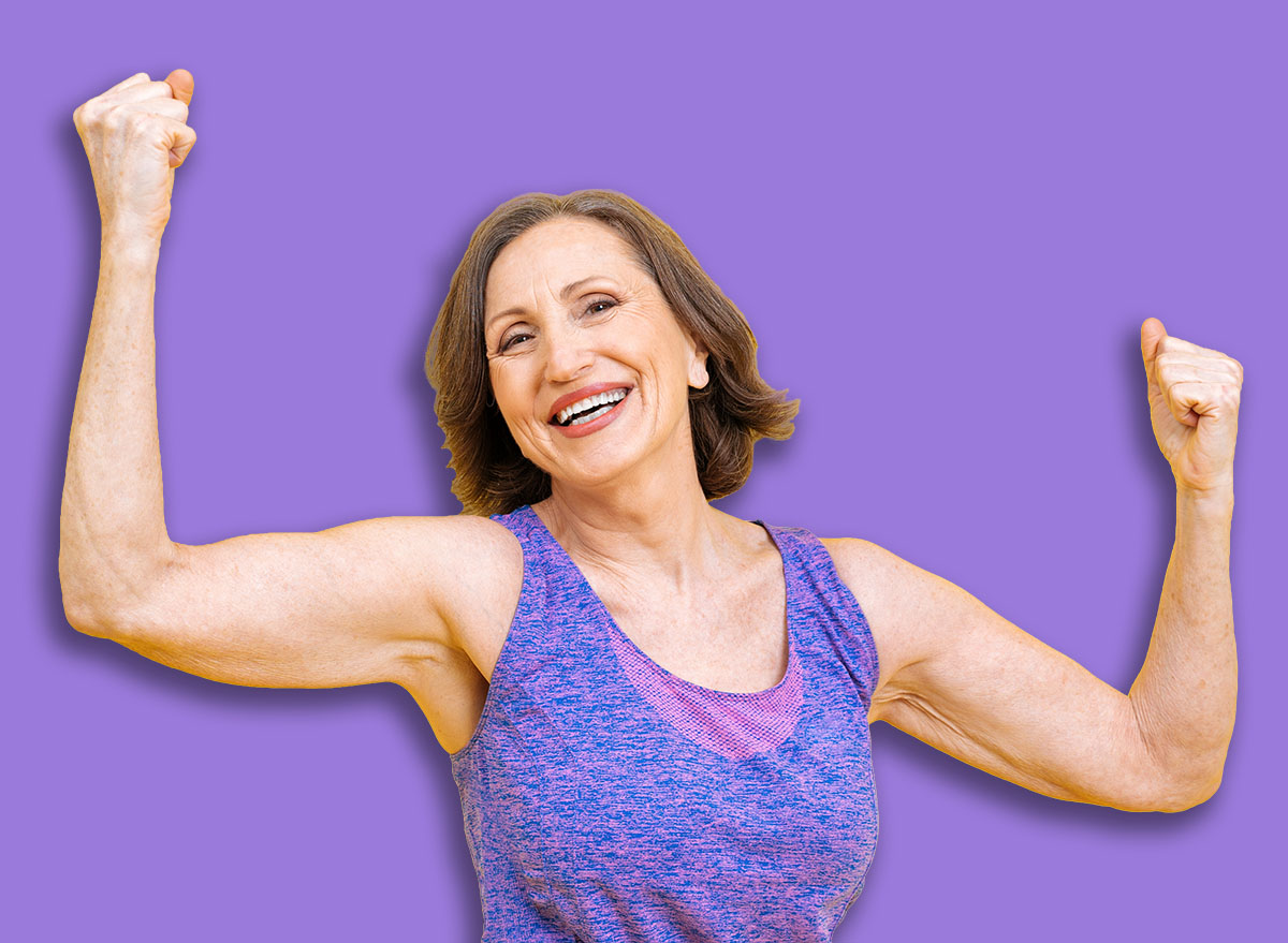 beautiful middle aged woman making sport at the gym. Senior female model posing for a body positive and self acceptance concept photoshooting on colored backgrounds